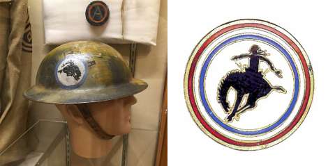 George Ostrom's helmet and a pin he made, both bearing the bucking bronco logo he designed. Wyoming Veterans Memorial Museum. George Ostrom's helmet and a pin he made, both bearing the bucking bronco logo he designed. Wyoming Veterans Memorial Museum.