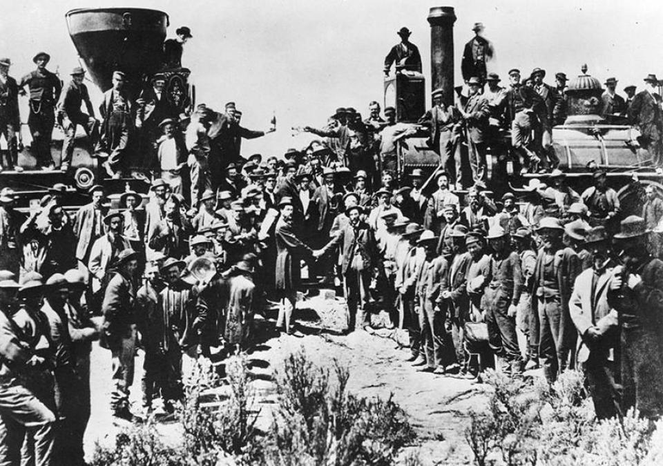 Celebrations for the driving of the Golden Spike at Promontory, Utah, May 10, 1868. The two men shaking hands at center are Samuel Montague, left, of the Central Pacific Railroad and Grenville Dodge of the Union Pacific. 