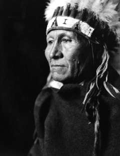 Northern Arapaho Council Chief Lone Bear, shown here in traditional dress, objected in 1904 that the 1.5 million acres north of the Big Wind River were worth twice what the government was offering. Joseph Dixon photo, Wyoming Veterans Memorial Museum.