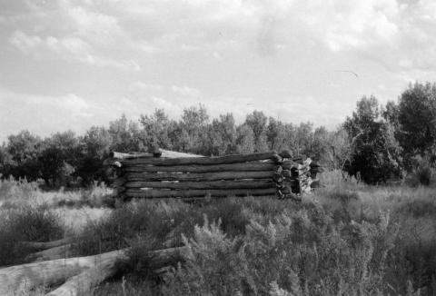 roofless log structure that seems to have fallen down