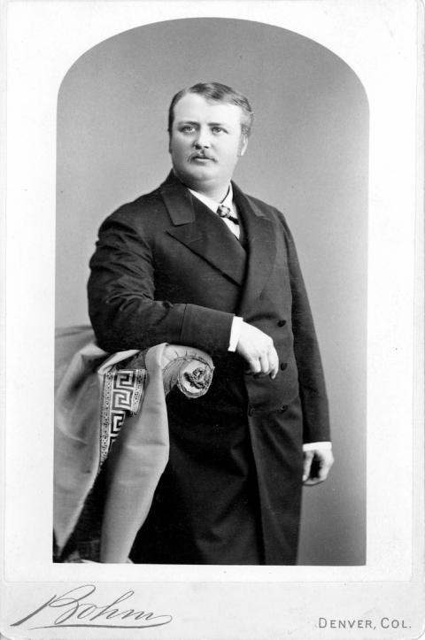 Man in a suit poses for a professional portrait