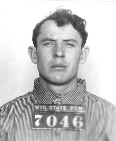 headshot of Melvin Gray in prison uniform with "Wyo State Pen 7046" overprinted on his chest