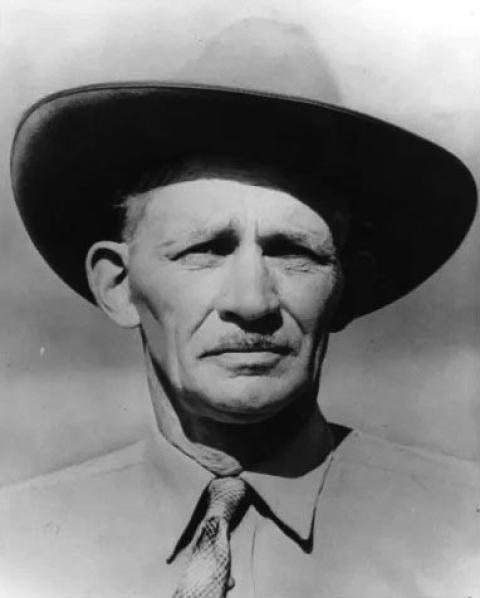 Portrait of a man with a mustache wearing a cowboy hat