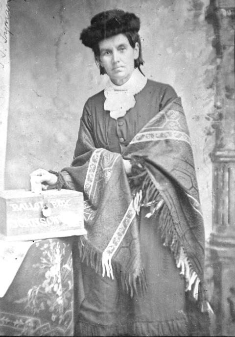 Dr. Delilah S. Turner Sonnesberger poses with a locked ballot box, her ballot partially cast.