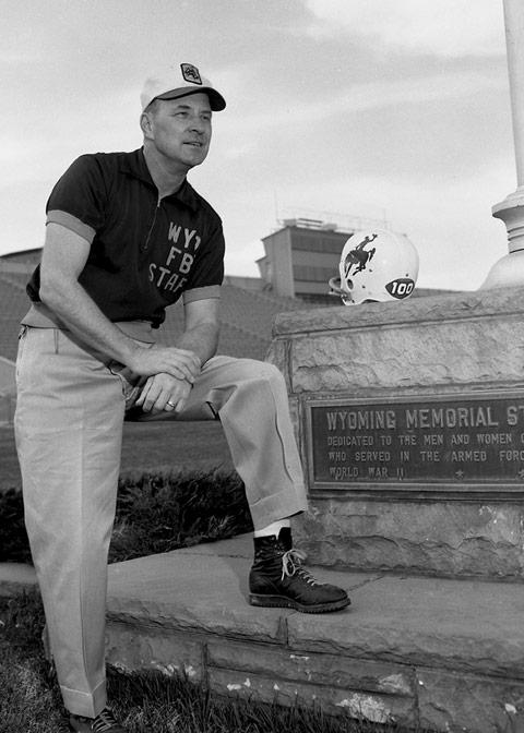 White man in a short-sleeved zip-front jersey with the words "WYO FB STAFF" across the left breast poses